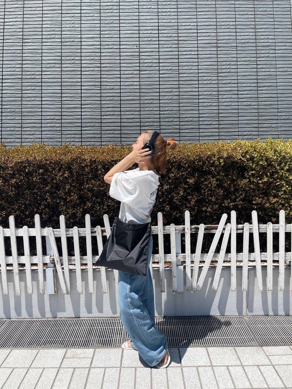 ブルー系のデニムパンツ、ホワイト系のTシャツ/カットソーを着用したレディースの春コーディネートの3枚目の写真