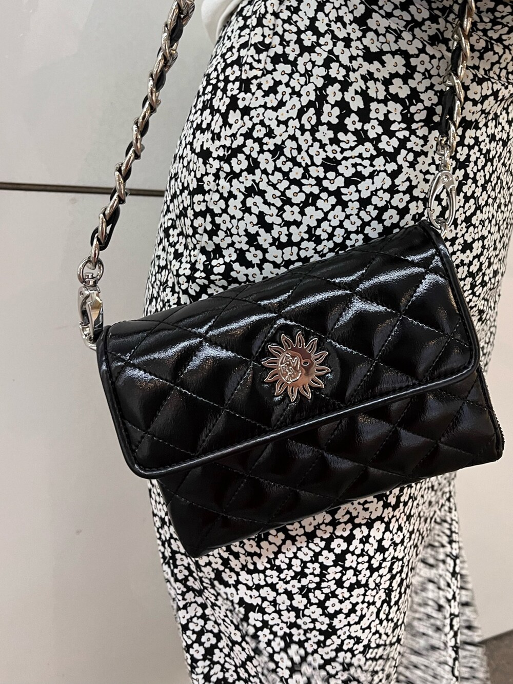 ブラック系のブーツ、ブラック系のワンピース、ブラック系のショルダーバッグを着用したレディースの春コーディネートの6枚目の写真