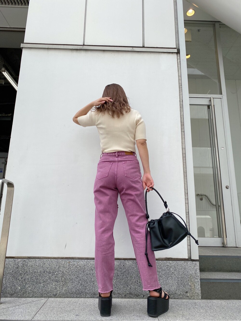 ブラック系のショルダーバッグ、ブラック系のサンダル、ホワイト系のTシャツ/カットソーを着用したレディースの春コーディネートの7枚目の写真