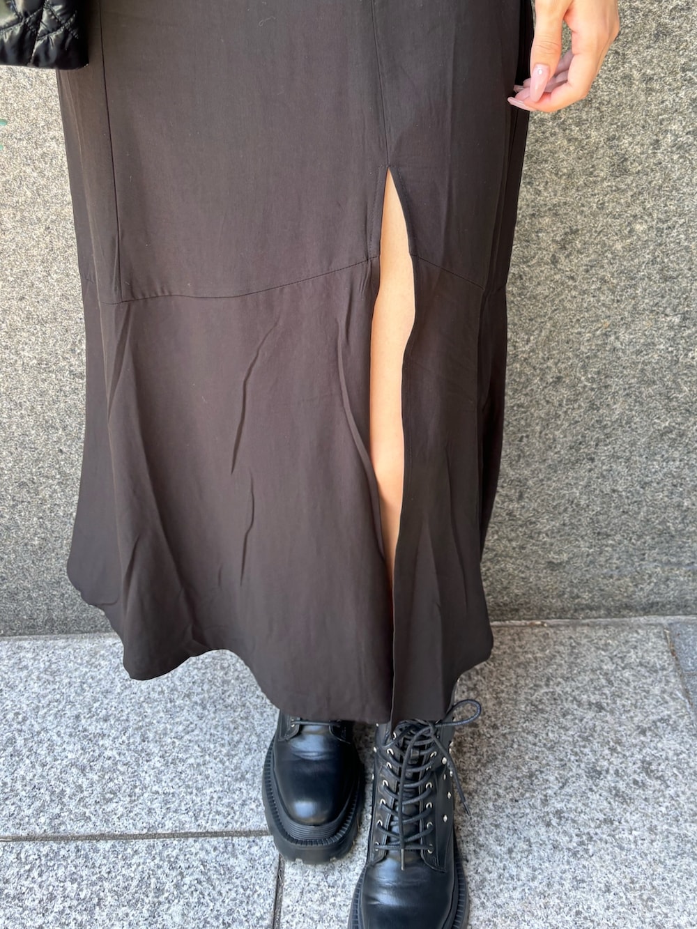 ブラック系のワンピース、ブラック系のショルダーバッグ、ブラック系のブーツを着用したレディースの春コーディネートの4枚目の写真