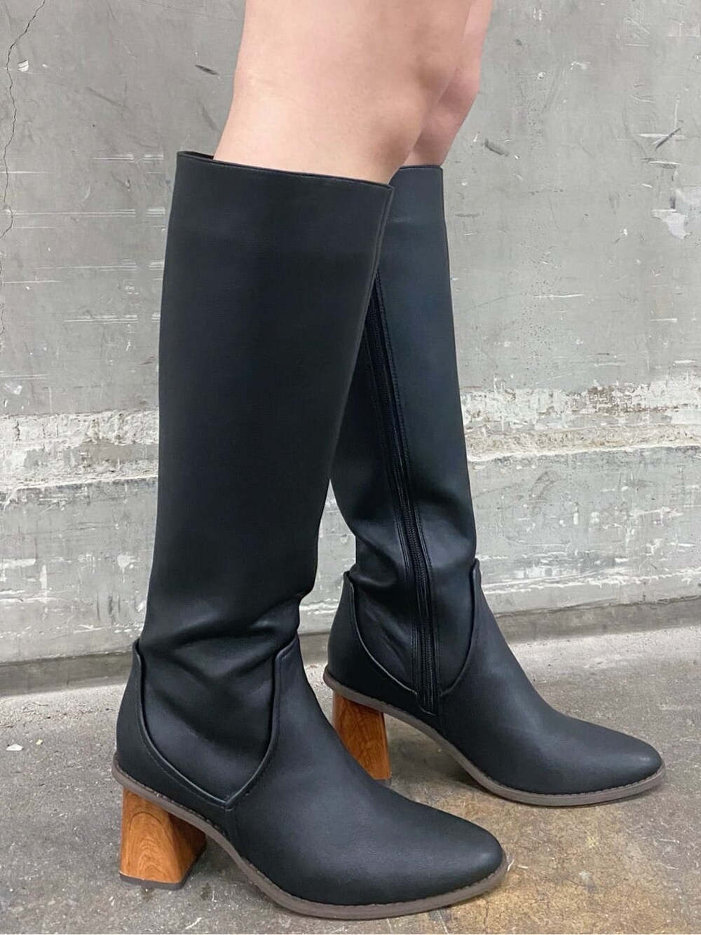 ブラック系のブーツ、グレー系のスウェット、ブラック系のスカートを着用したレディースの冬コーディネートの6枚目の写真