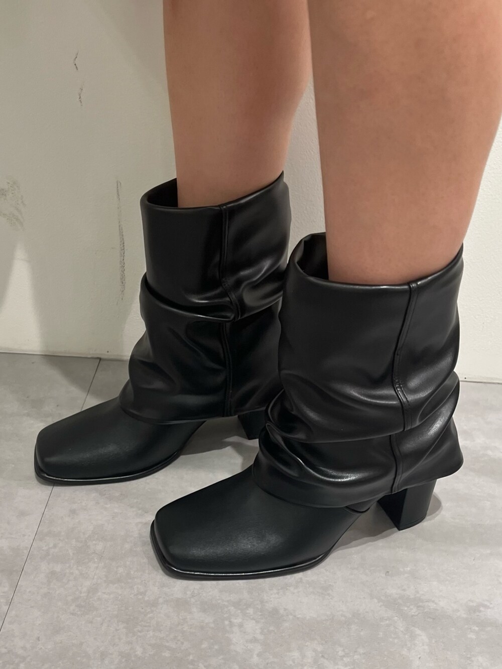 ホワイト系のニット/セーター、ブラック系のスカート、ブラック系のショルダーバッグを着用したレディースの冬コーディネートの5枚目の写真