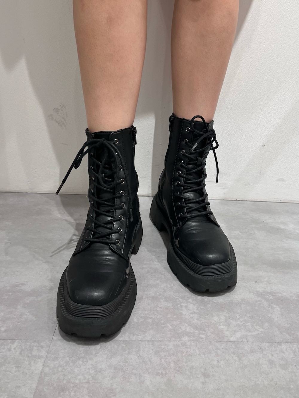 ブラック系のTシャツ/カットソー、グリーン系のスカート、ブラック系のブーツを着用したレディースの夏コーディネートの6枚目の写真