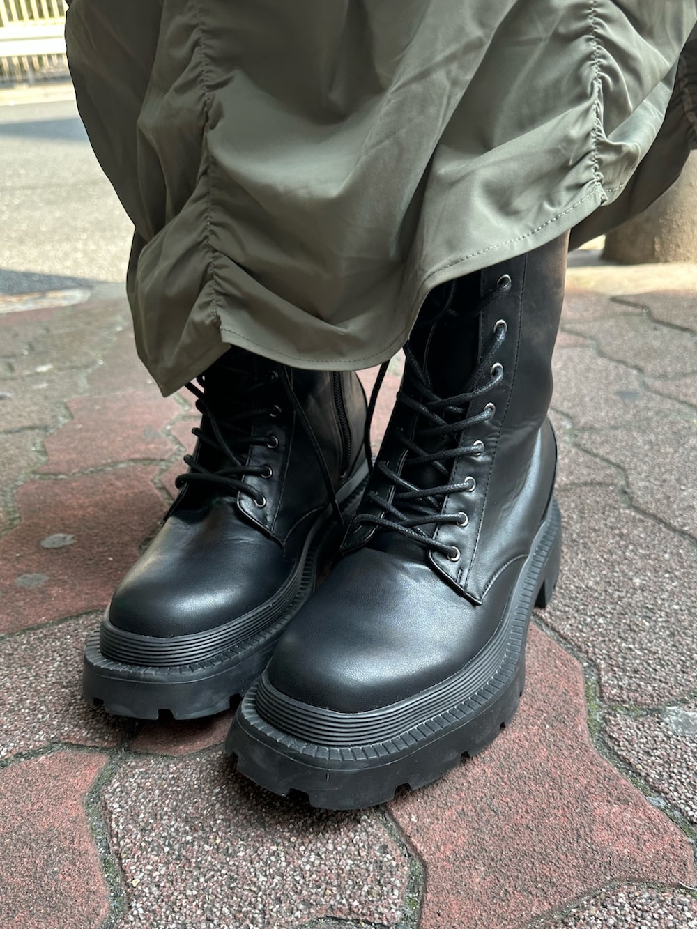 ベージュ系のスカート、ブラック系のカーディガン/ボレロ、ブラック系のショルダーバッグを着用したレディースの春コーディネートの8枚目の写真