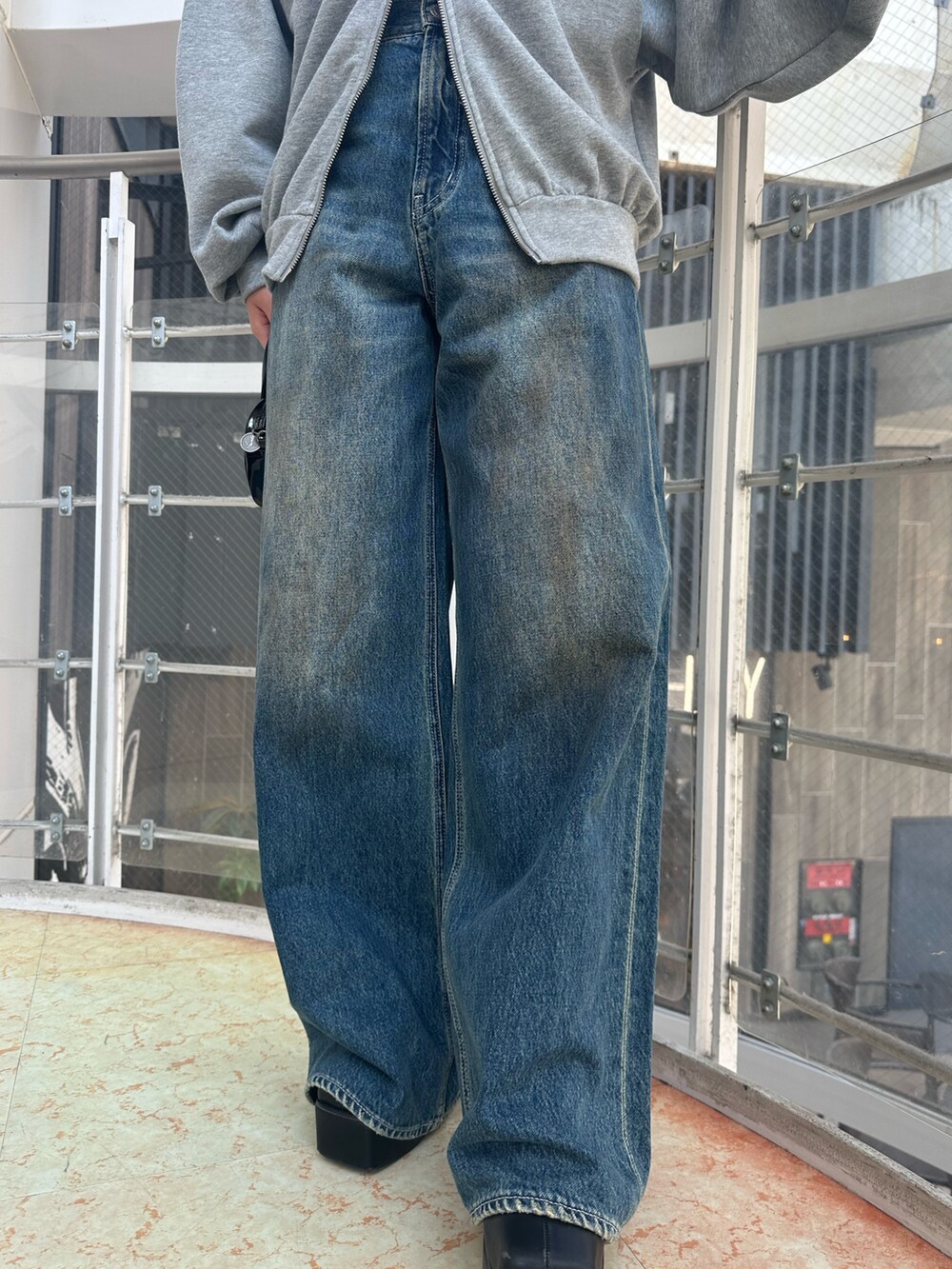 ブルー系のデニムパンツ、グレー系のパーカー、ブラック系のハンドバッグを着用したレディースの秋コーディネートの9枚目の写真