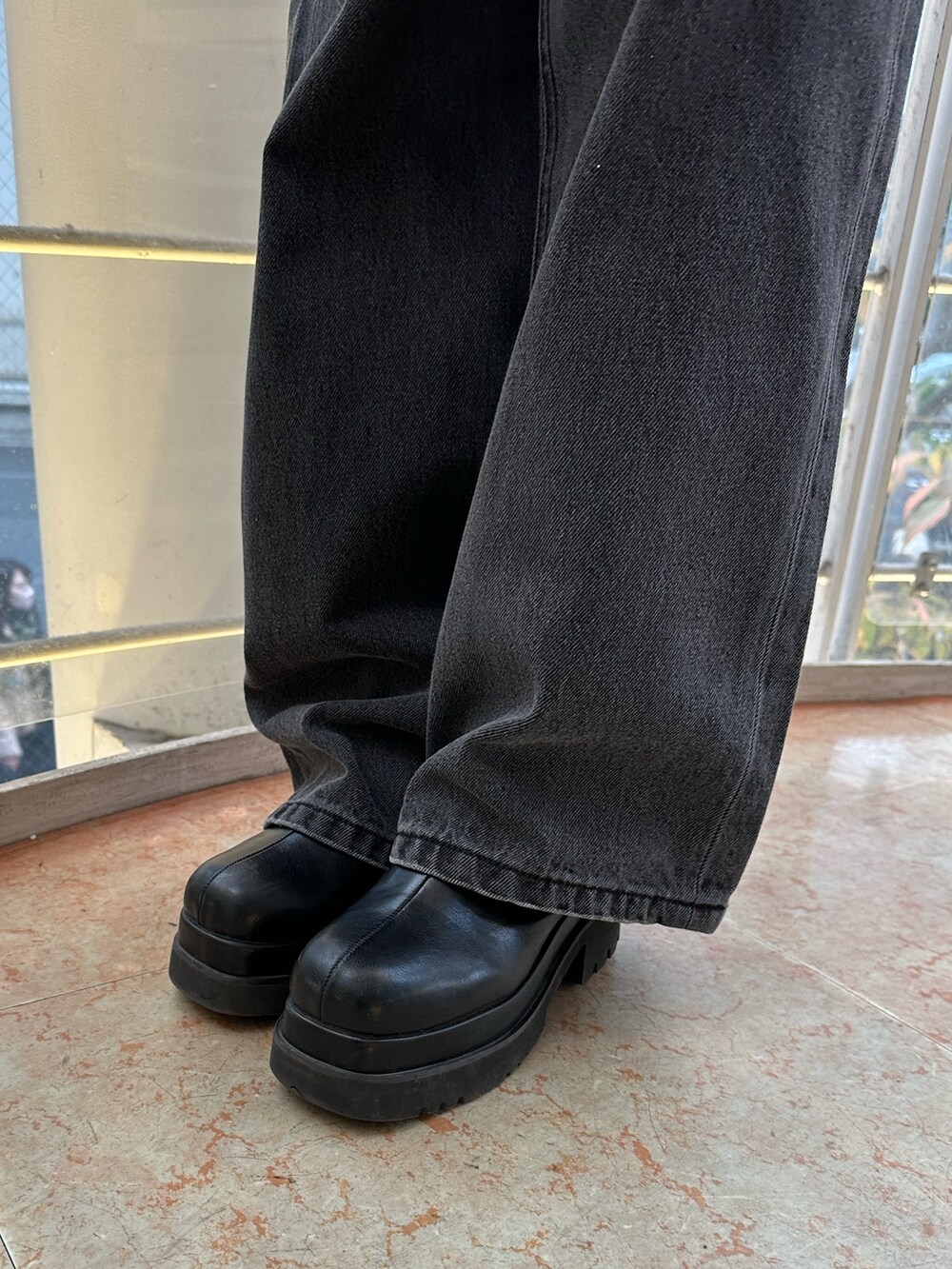 ブラック系のショルダーバッグ、ブラック系のデニムパンツ、ブラック系のTシャツ/カットソーを着用したレディースの冬コーディネートの8枚目の写真