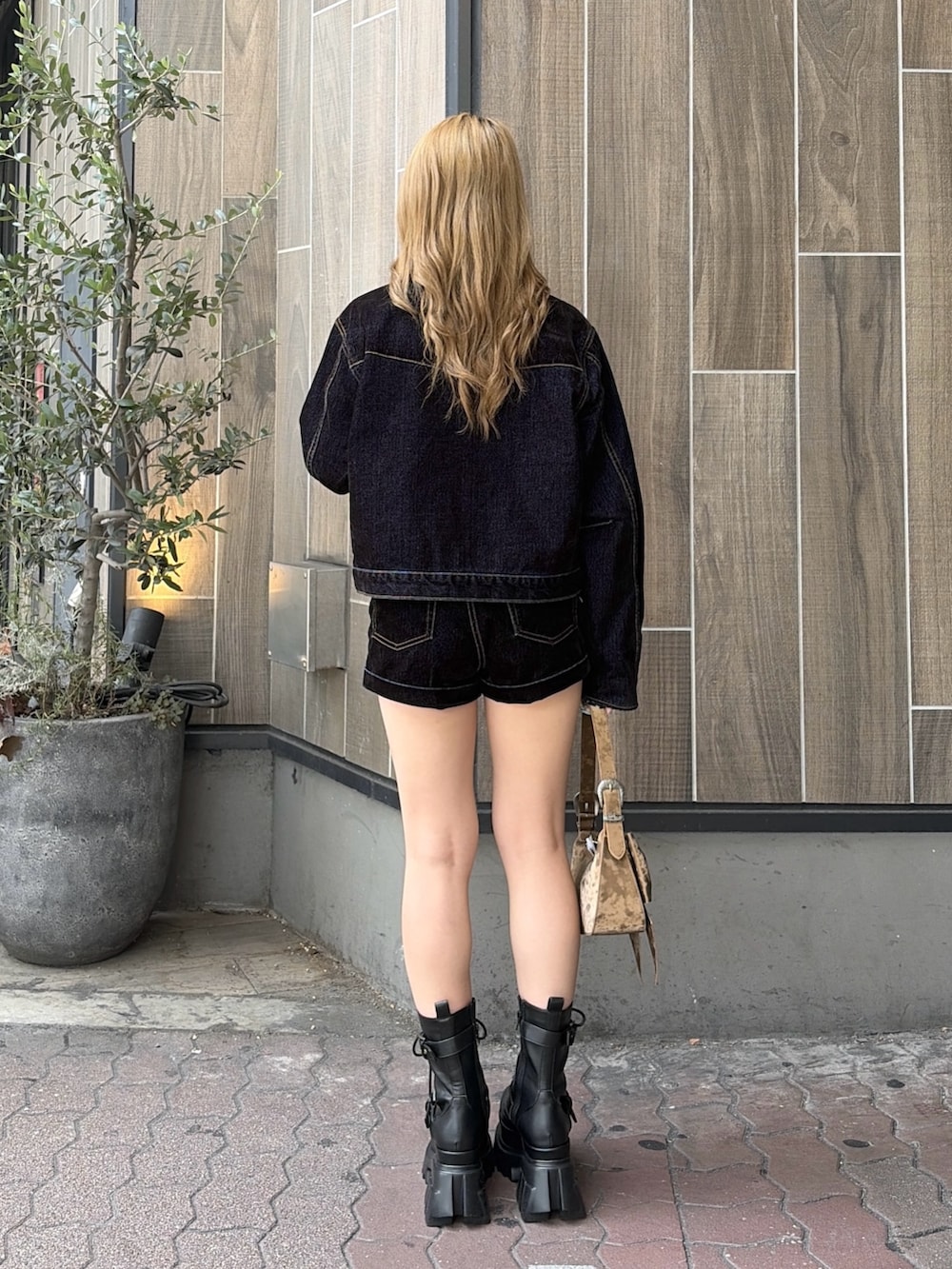 ブルー系のその他パンツ、ブルー系のデニムジャケット、ブラウン系のハンドバッグを着用したレディースの夏コーディネートの3枚目の写真