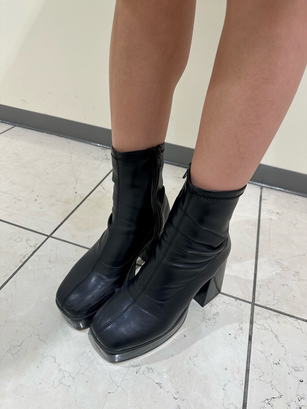 ブラック系のブーツ、ブラック系のニット/セーター、グリーン系のダウンジャケット/コートを着用したレディースの冬コーディネートの8枚目の写真