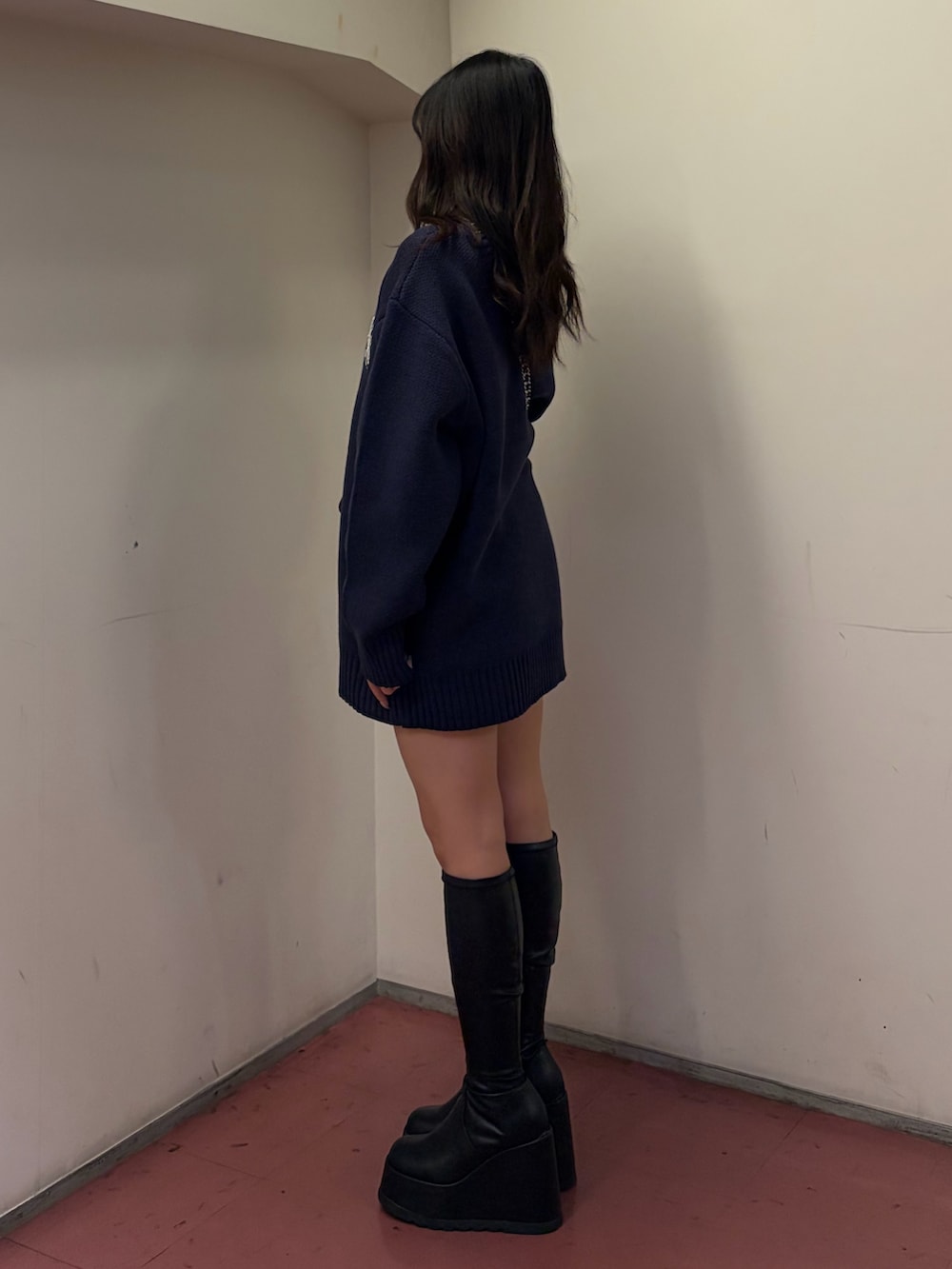 ブラック系のブーツ、ブラック系のショルダーバッグ、ブルー系のニット/セーターを着用したレディースの冬コーディネートの2枚目の写真