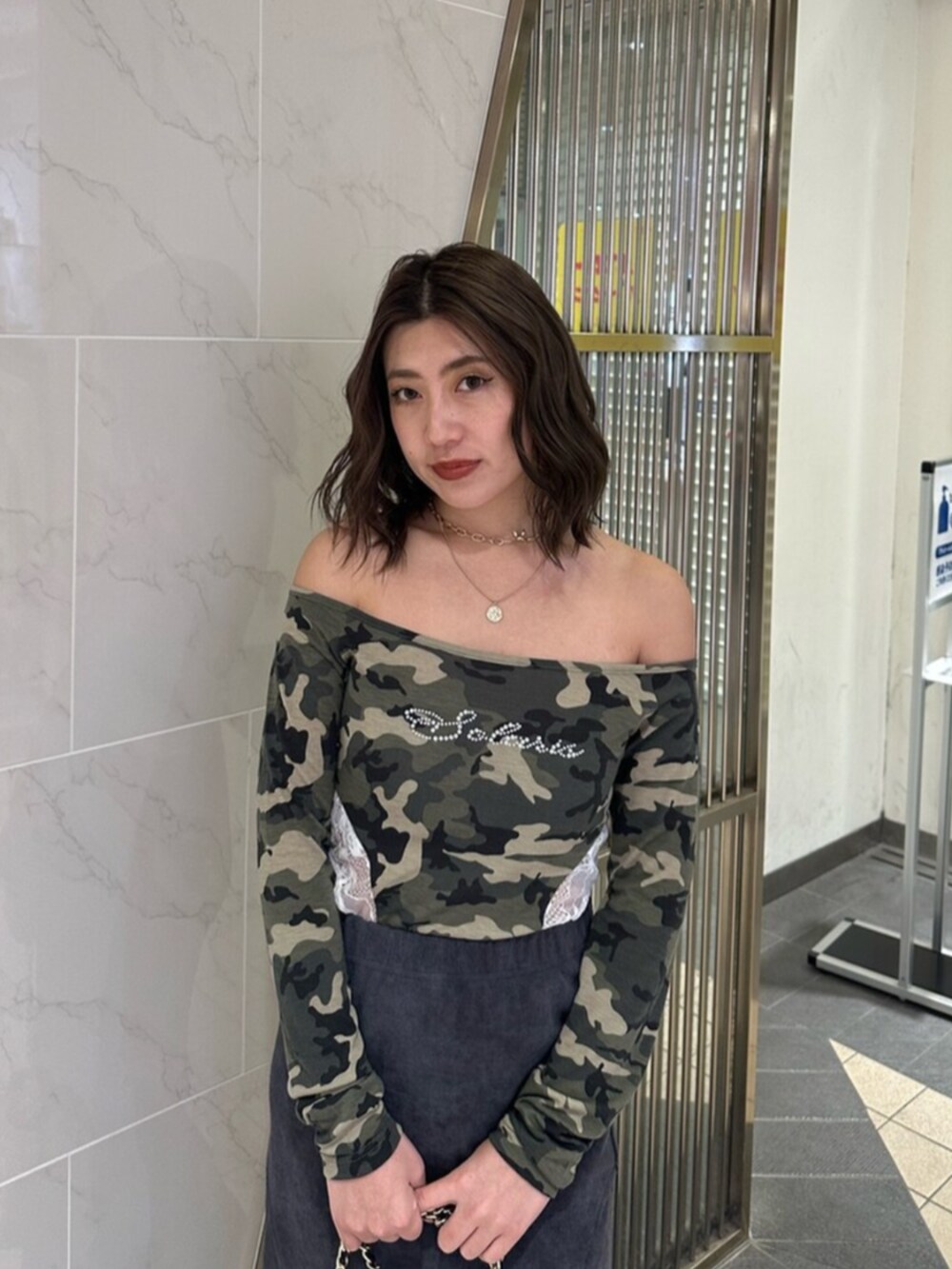 ブラック系のブーツ、ブラック系のスカート、ブラック系のショルダーバッグを着用したレディースの冬コーディネートの5枚目の写真