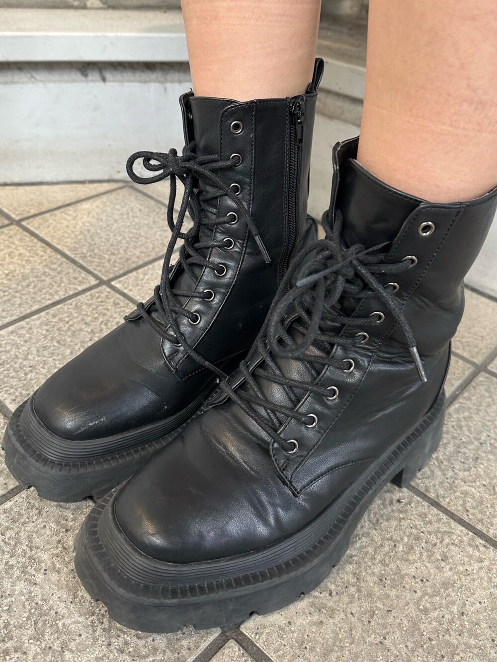 ブラック系のその他パンツ、ブラック系のブーツ、グレー系のニット/セーターを着用したレディースの冬コーディネートの7枚目の写真