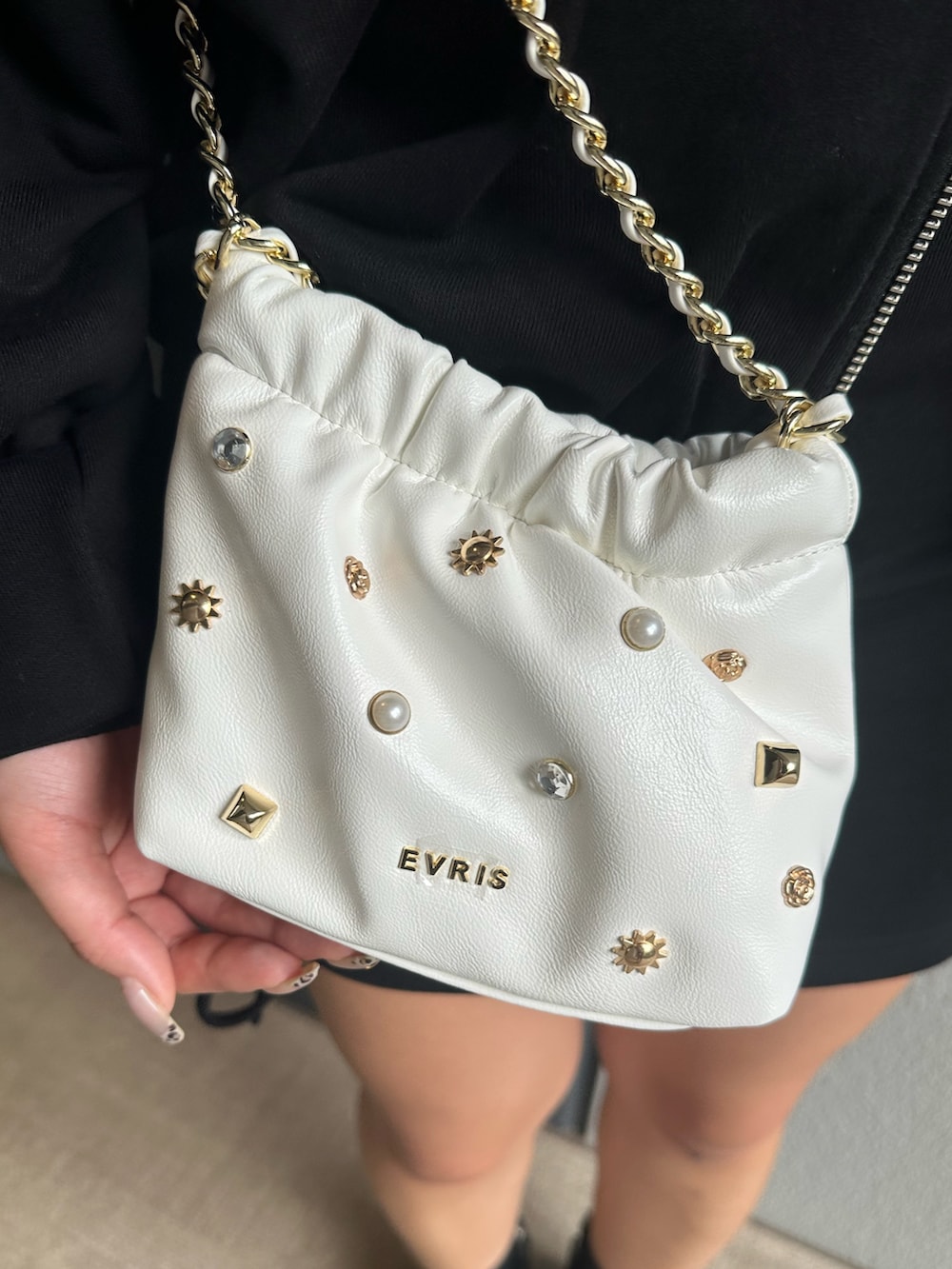 ブラック系のパーカー、ブラック系のスカート、ブラック系のブーツを着用したレディースの秋コーディネートの6枚目の写真