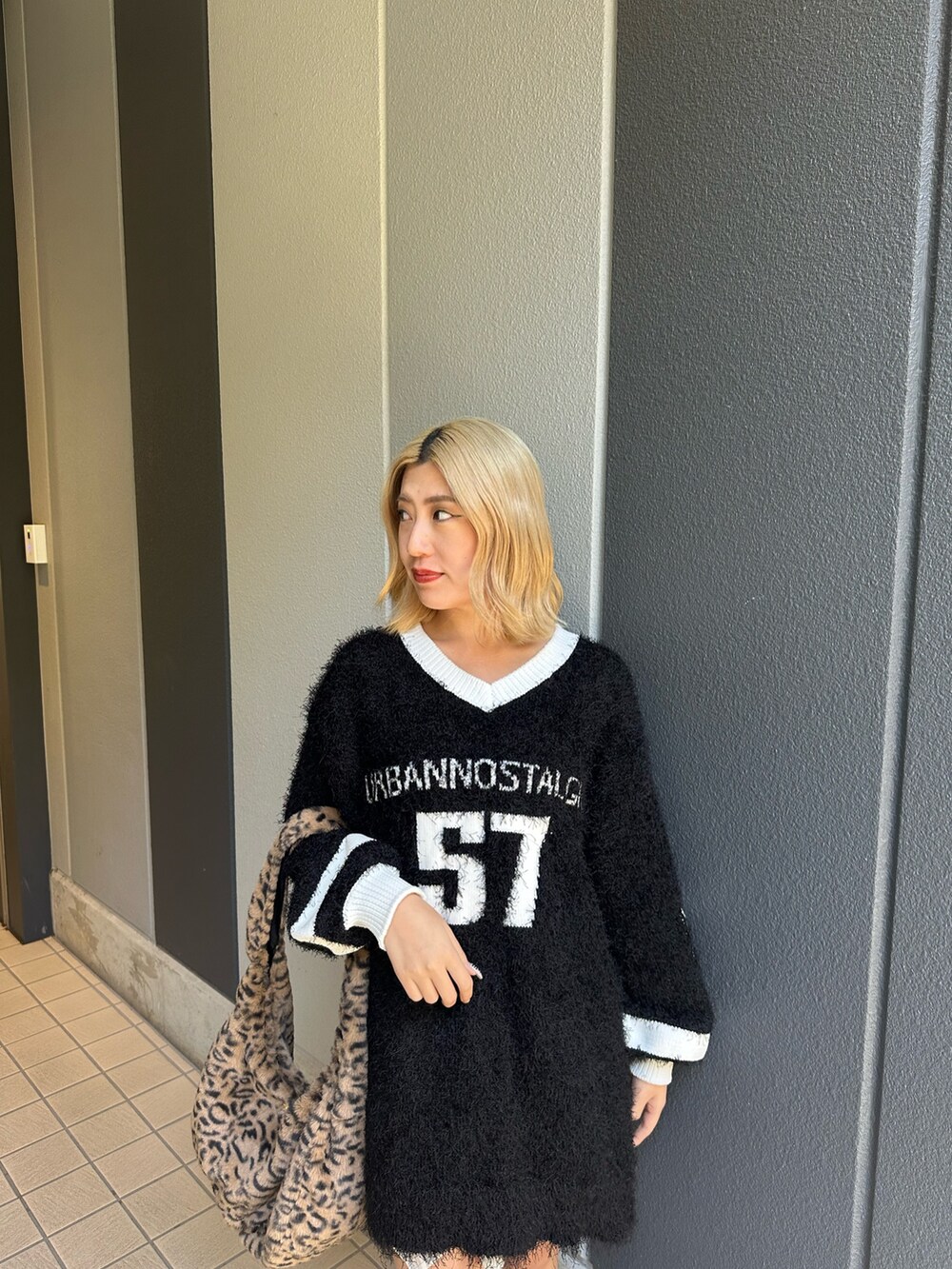 その他のブーツ、ブラック系のニット/セーター、その他のショルダーバッグを着用したレディースの秋コーディネートの4枚目の写真