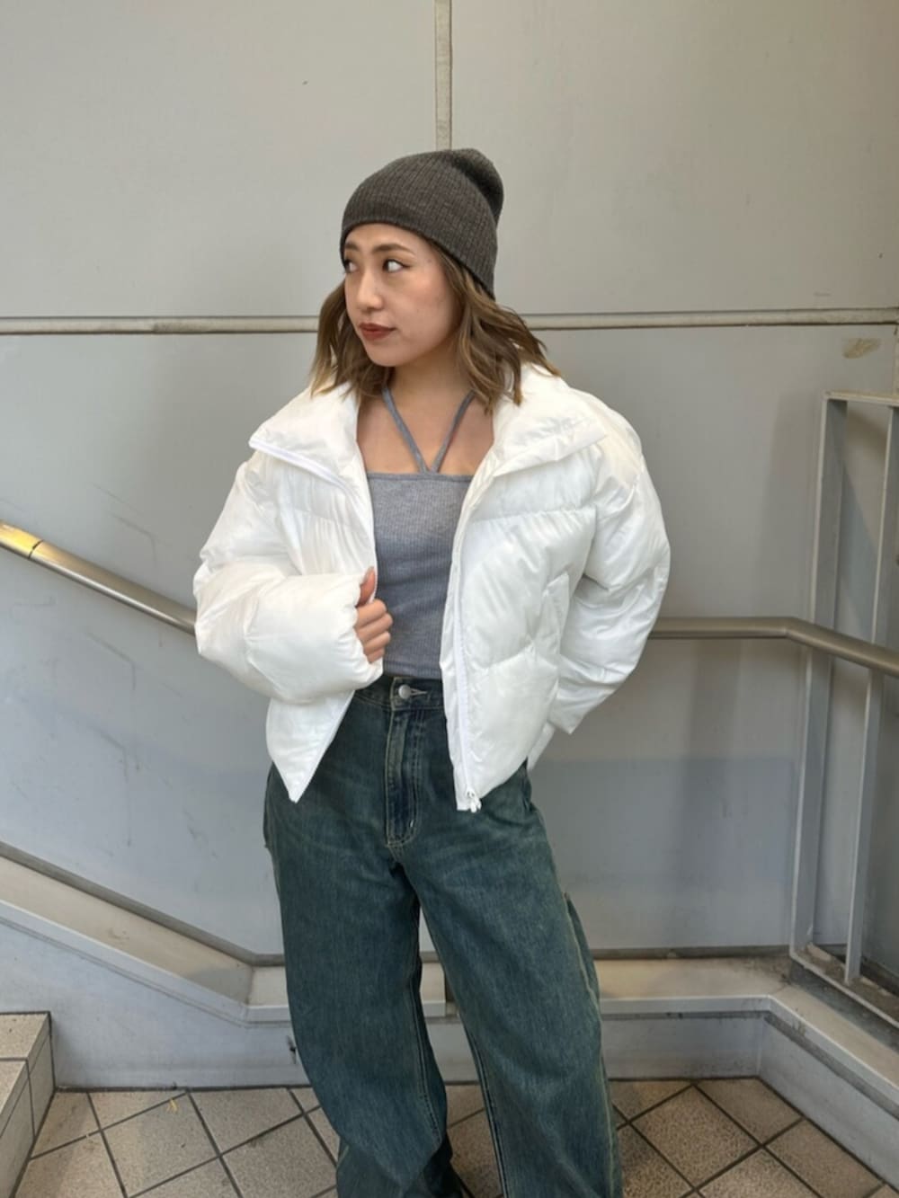 ブルー系のデニムパンツ、ホワイト系のブルゾン、グレー系のTシャツ/カットソーを着用したレディースの冬コーディネートの4枚目の写真