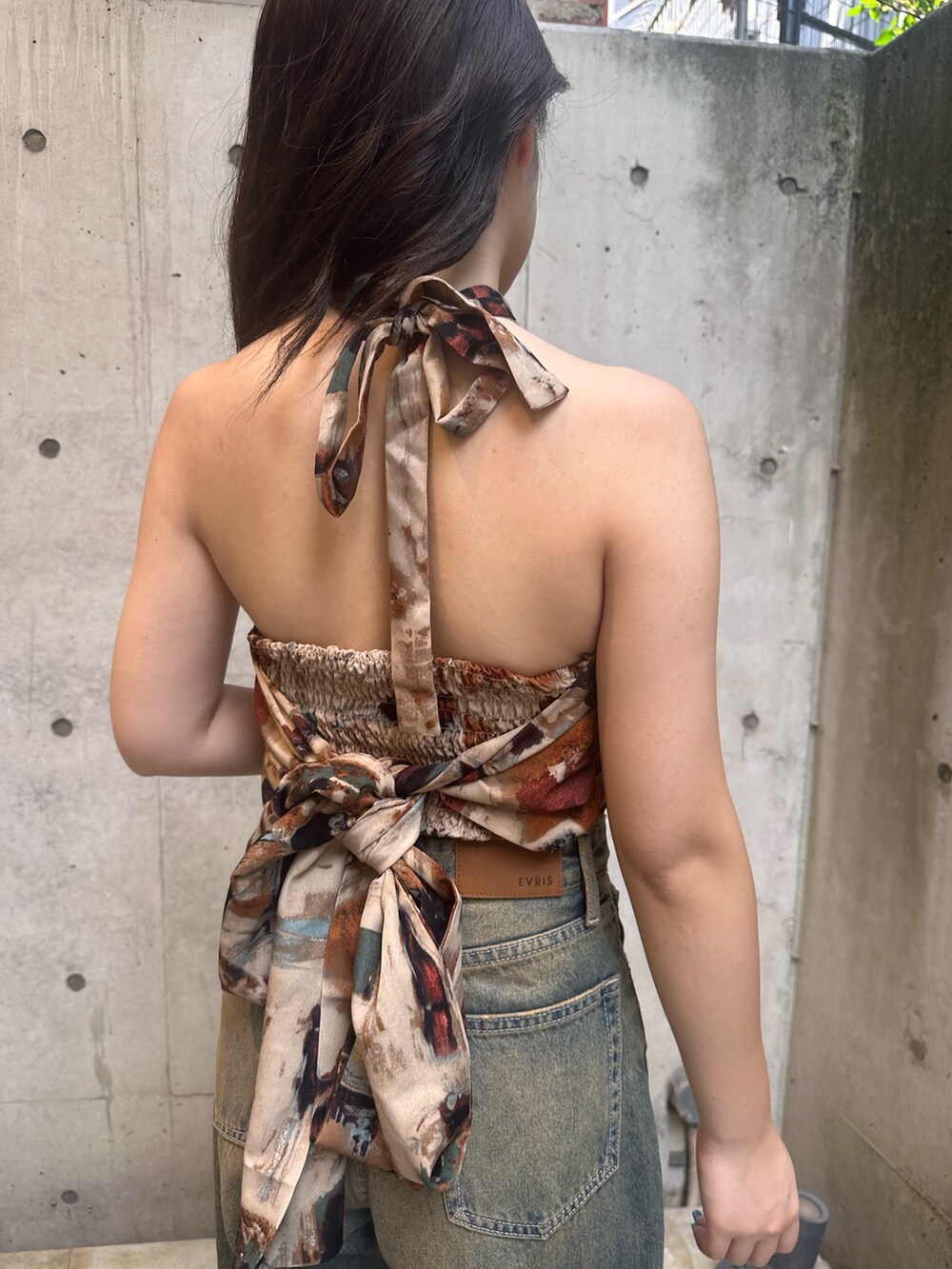 ブラウン系のTシャツ/カットソー、ブルー系のデニムパンツ、ブラック系のサンダルを着用したレディースの夏コーディネートの6枚目の写真