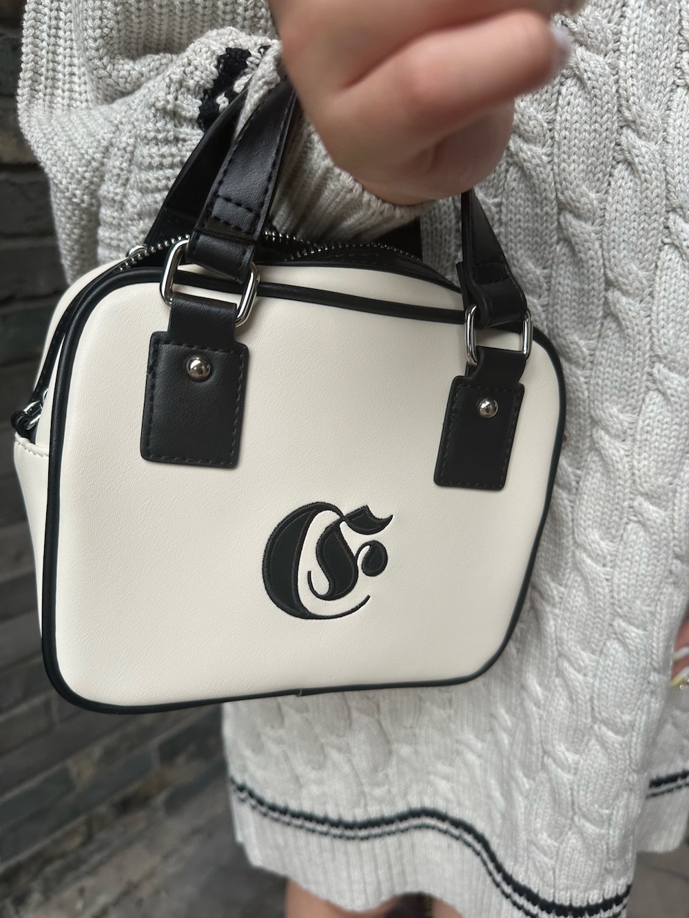 グレー系のニット/セーター、ホワイト系のショルダーバッグを着用したレディースの夏コーディネートの8枚目の写真