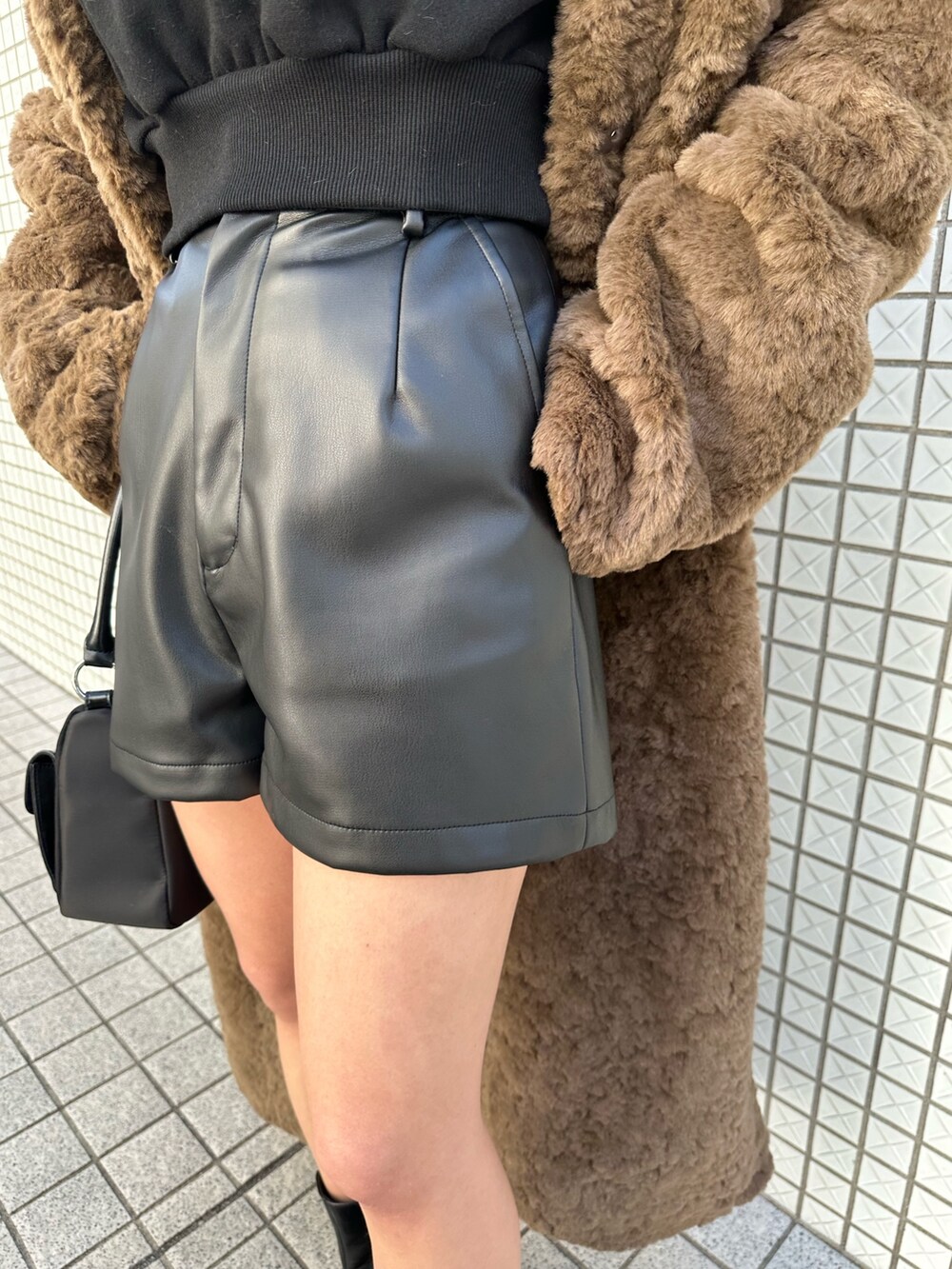 ブラック系のブーツ、ブラック系のハンドバッグ、ブラック系のその他パンツを着用したレディースの冬コーディネートの7枚目の写真