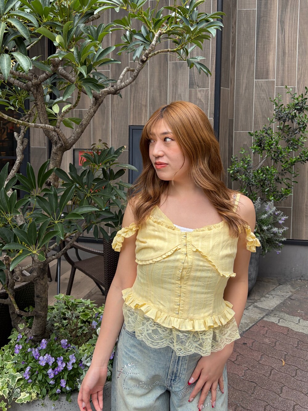 ブルー系のデニムパンツ、イエロー系のキャミソールを着用したレディースの春コーディネートの4枚目の写真