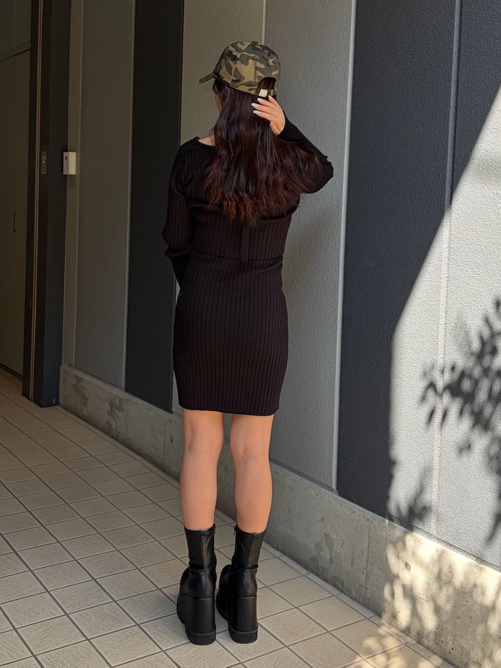 ブラック系のワンピース、ブラック系のブーツを着用したレディースの冬コーディネートの4枚目の写真