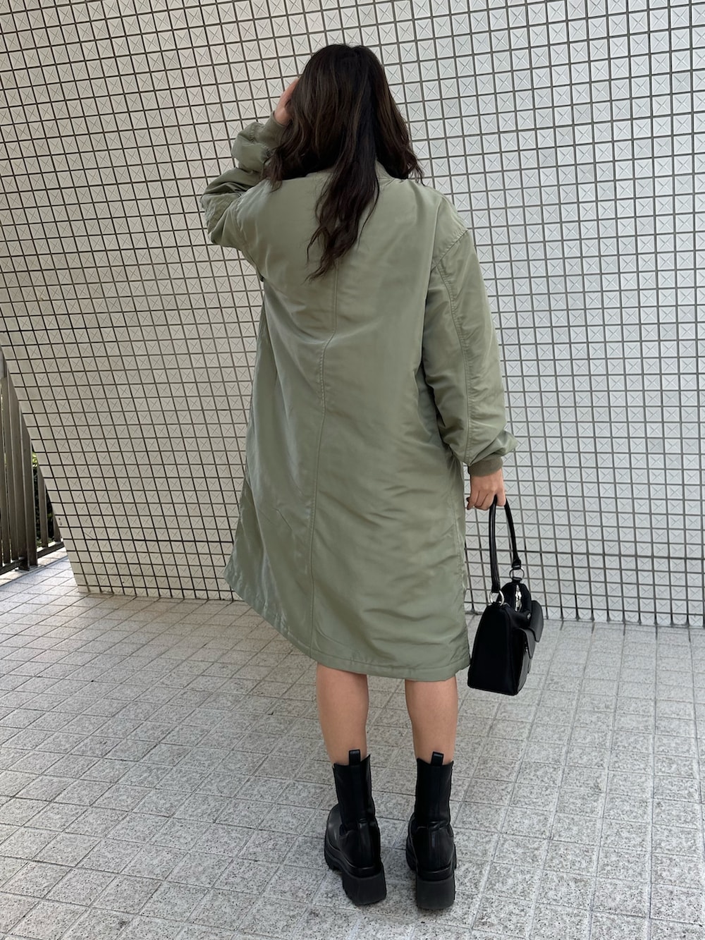 グレー系のニット/セーター、ブラック系のその他パンツ、ブラック系のブーツを着用したレディースの冬コーディネートの4枚目の写真