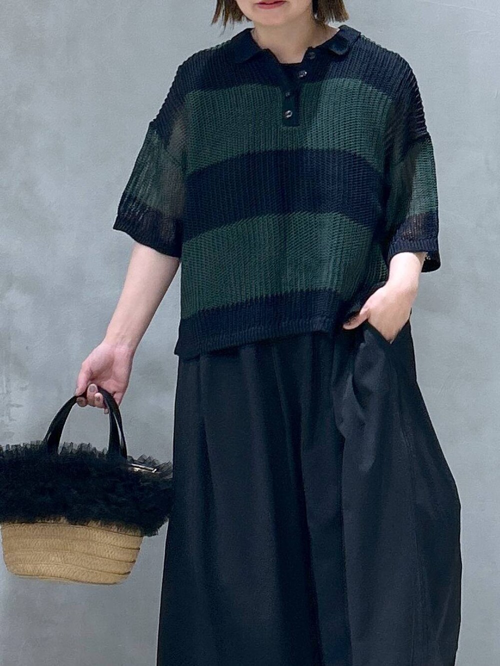 ブルー系のデニムパンツ、ベージュ系のショルダーバッグ、ブラック系のスニーカーを着用したレディースの春コーディネートの5枚目の写真