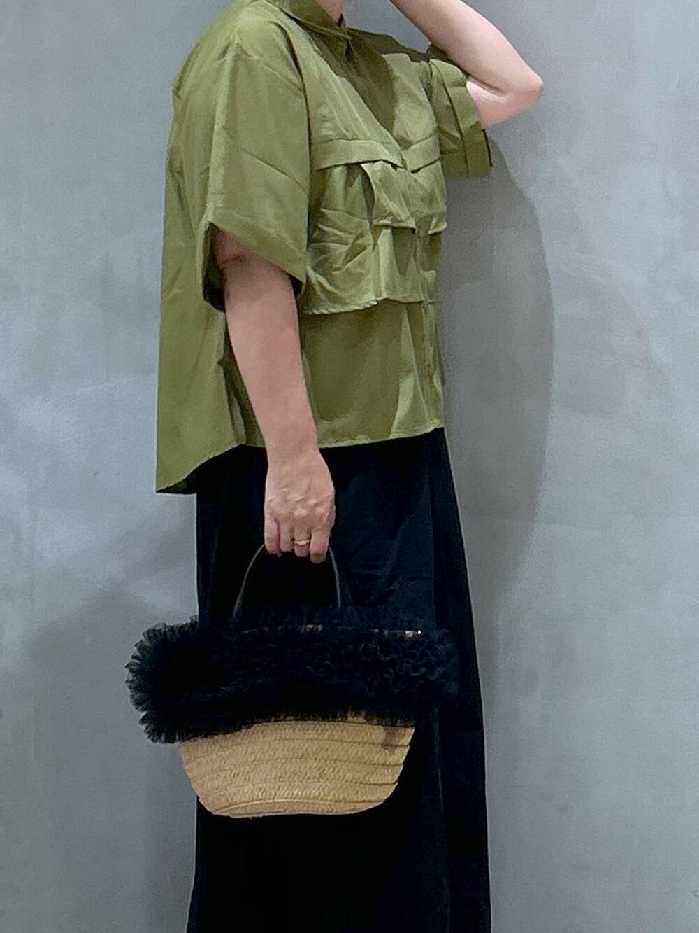 ブラック系のスカート、ベージュ系のショルダーバッグ、ブラック系のレインシューズを着用したレディースの夏コーディネートの6枚目の写真