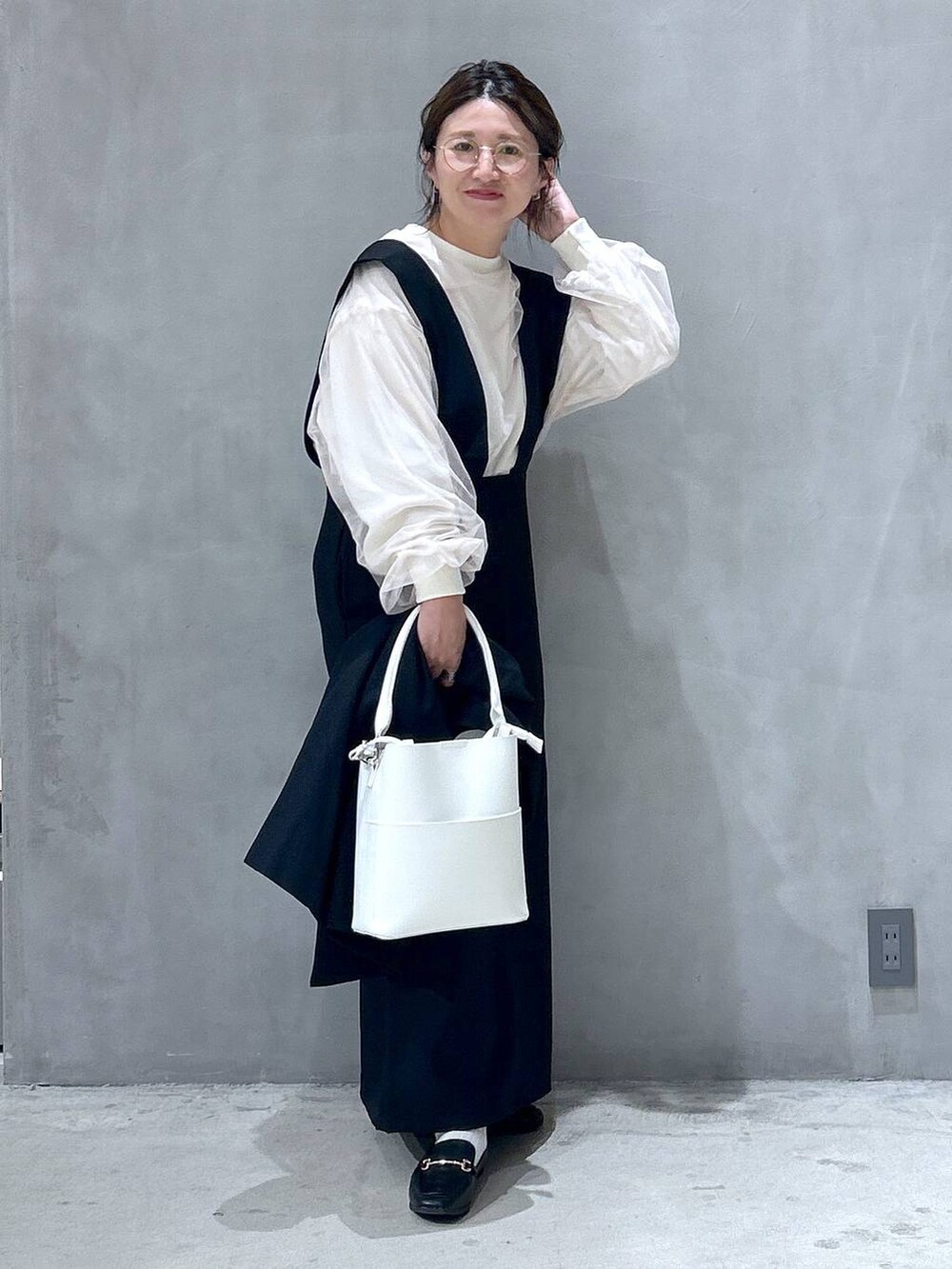 ブラック系のテーラードジャケット、ホワイト系のショルダーバッグ、ブラック系のローファーを着用したレディースの秋コーディネートの6枚目の写真