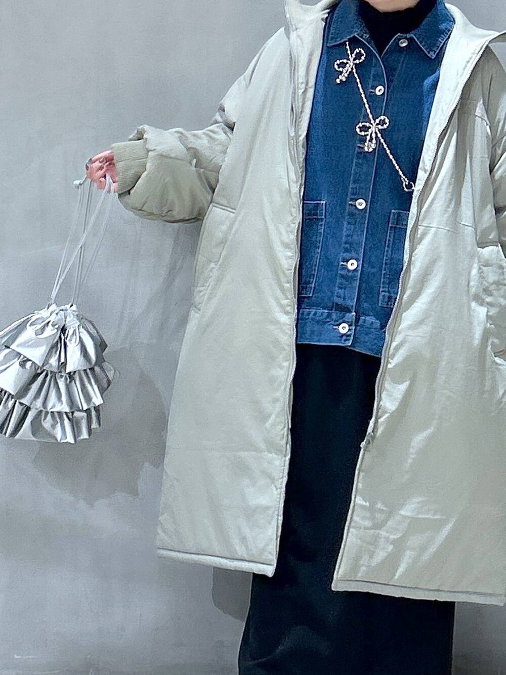 グリーン系のミリタリージャケット、ブラック系のスカート、シルバー系のショルダーバッグを着用したレディースの冬コーディネートの4枚目の写真