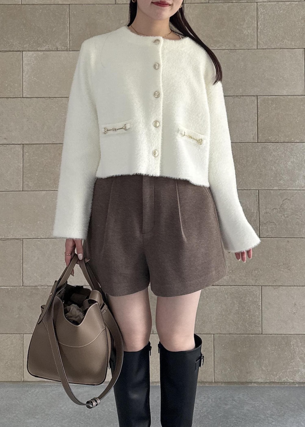 ブラック系のブーツ、ブラウン系のその他パンツ、ホワイト系のカーディガン/ボレロを着用したレディースの秋コーディネートの3枚目の写真