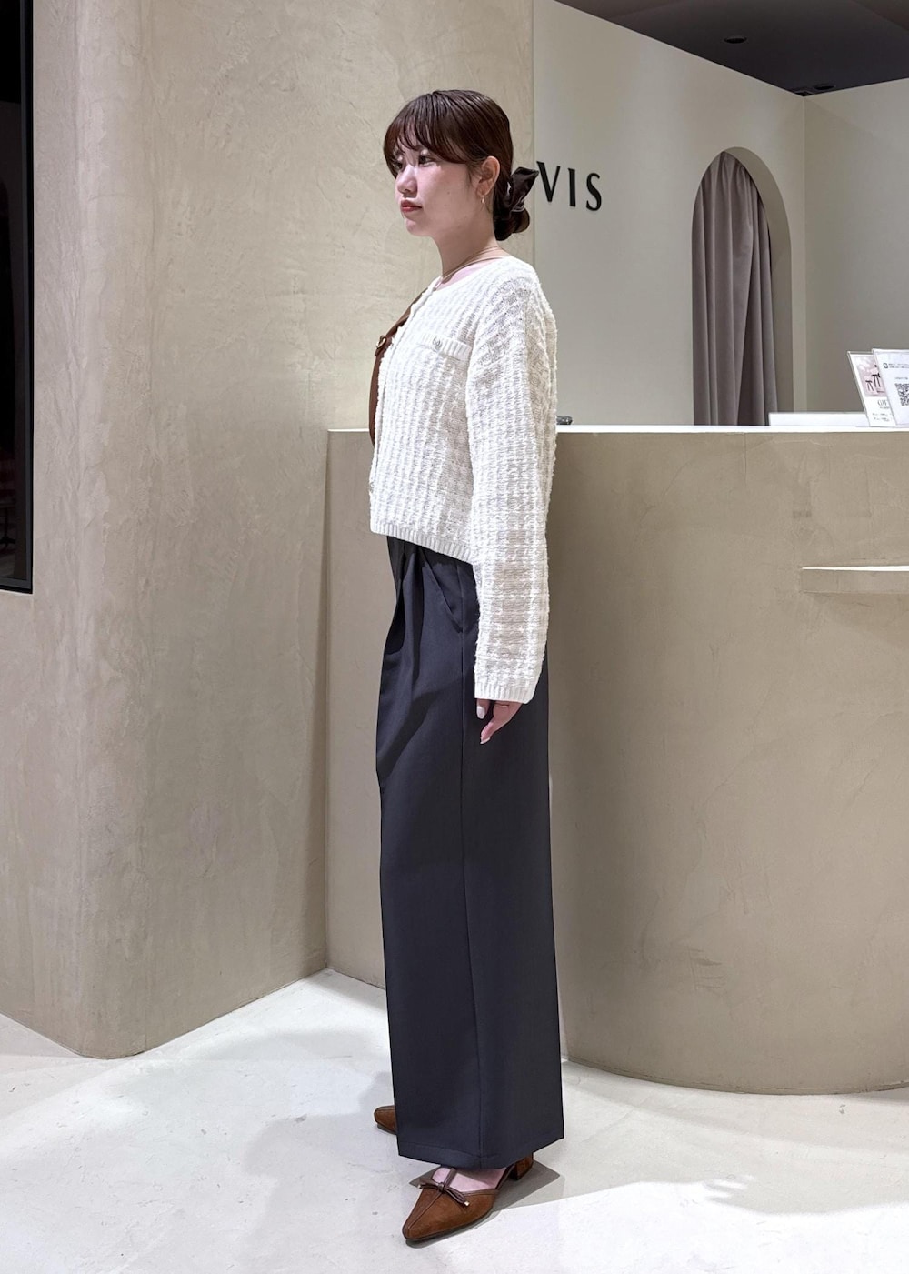 イエロー系のパンプス、ブラウン系のハンドバッグ、ホワイト系のカーディガン/ボレロを着用したレディースの秋コーディネートの4枚目の写真