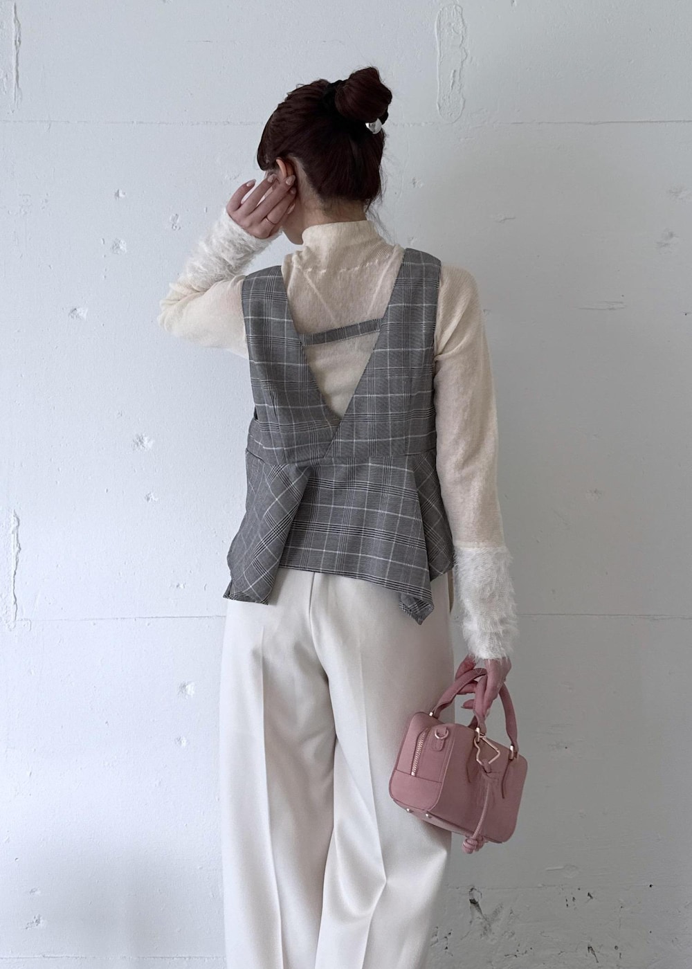 ホワイト系のスラックス、ピンク系のボストンバッグ、ベージュ系のブーツを着用したレディースの秋コーディネートの6枚目の写真
