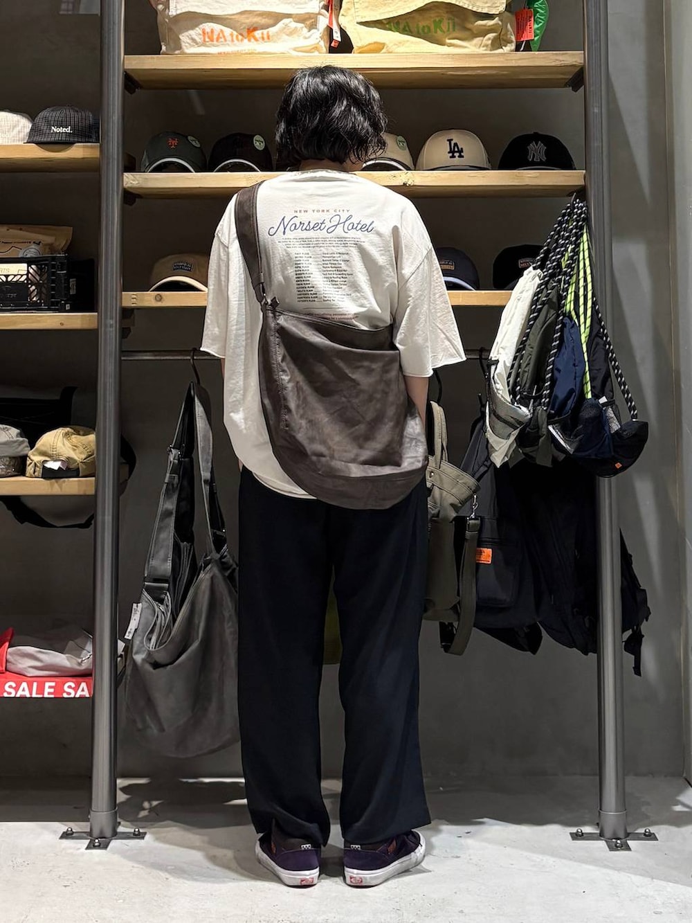 ブラウン系のショルダーバッグ、ホワイト系のTシャツ/カットソー、ブラック系のその他パンツを着用したメンズの夏コーディネートの3枚目の写真