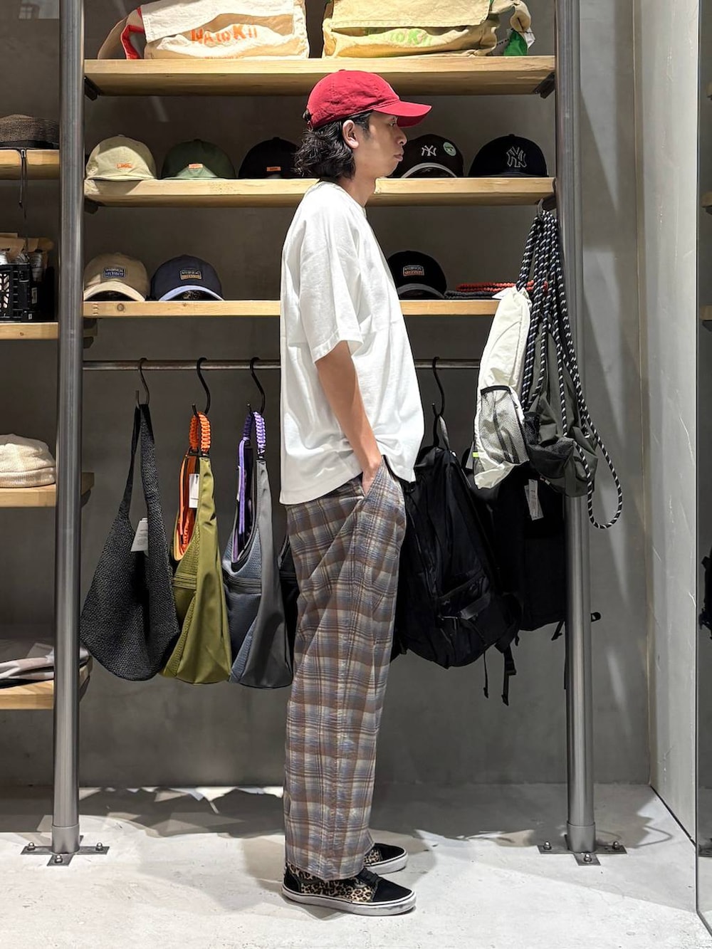 ブラウン系のその他パンツ、ホワイト系のTシャツ/カットソー、レッド系のキャップを着用したメンズの夏コーディネートの2枚目の写真