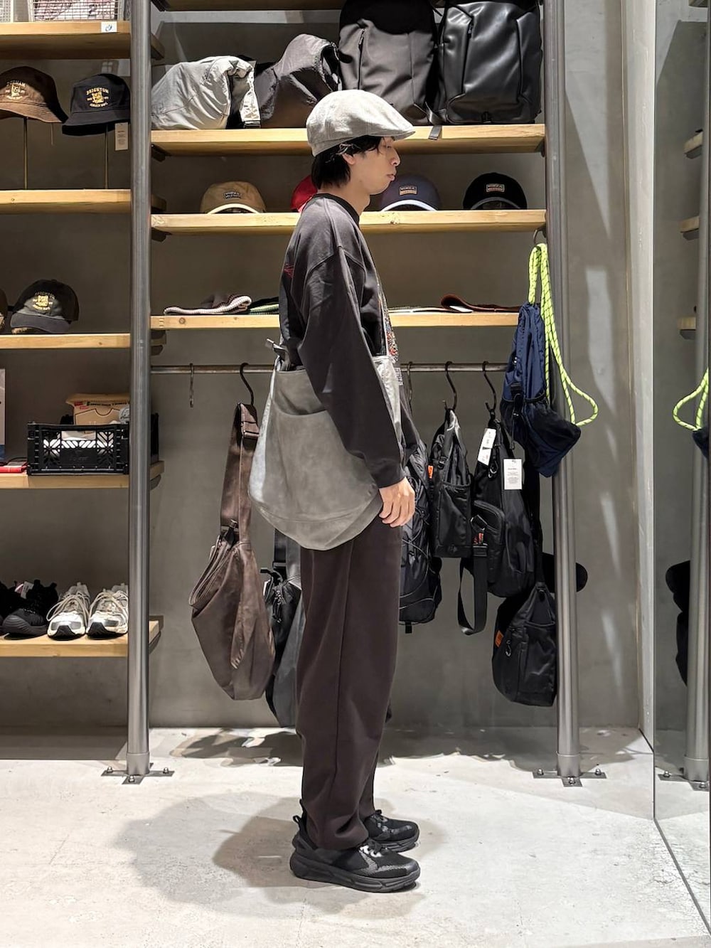 グレー系のショルダーバッグ、ブラウン系のスウェットパンツ、グレー系のスウェットを着用したメンズの秋コーディネートの2枚目の写真