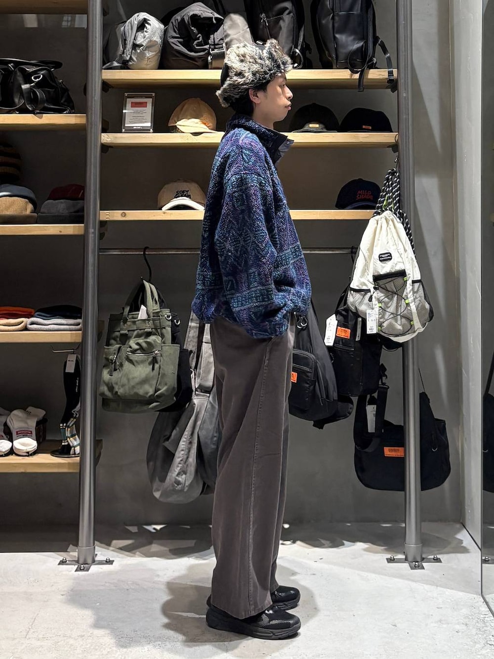 ブラウン系のチノパンツ、ブルー系のその他トップス、ブラック系のキャップを着用したメンズの秋コーディネートの2枚目の写真
