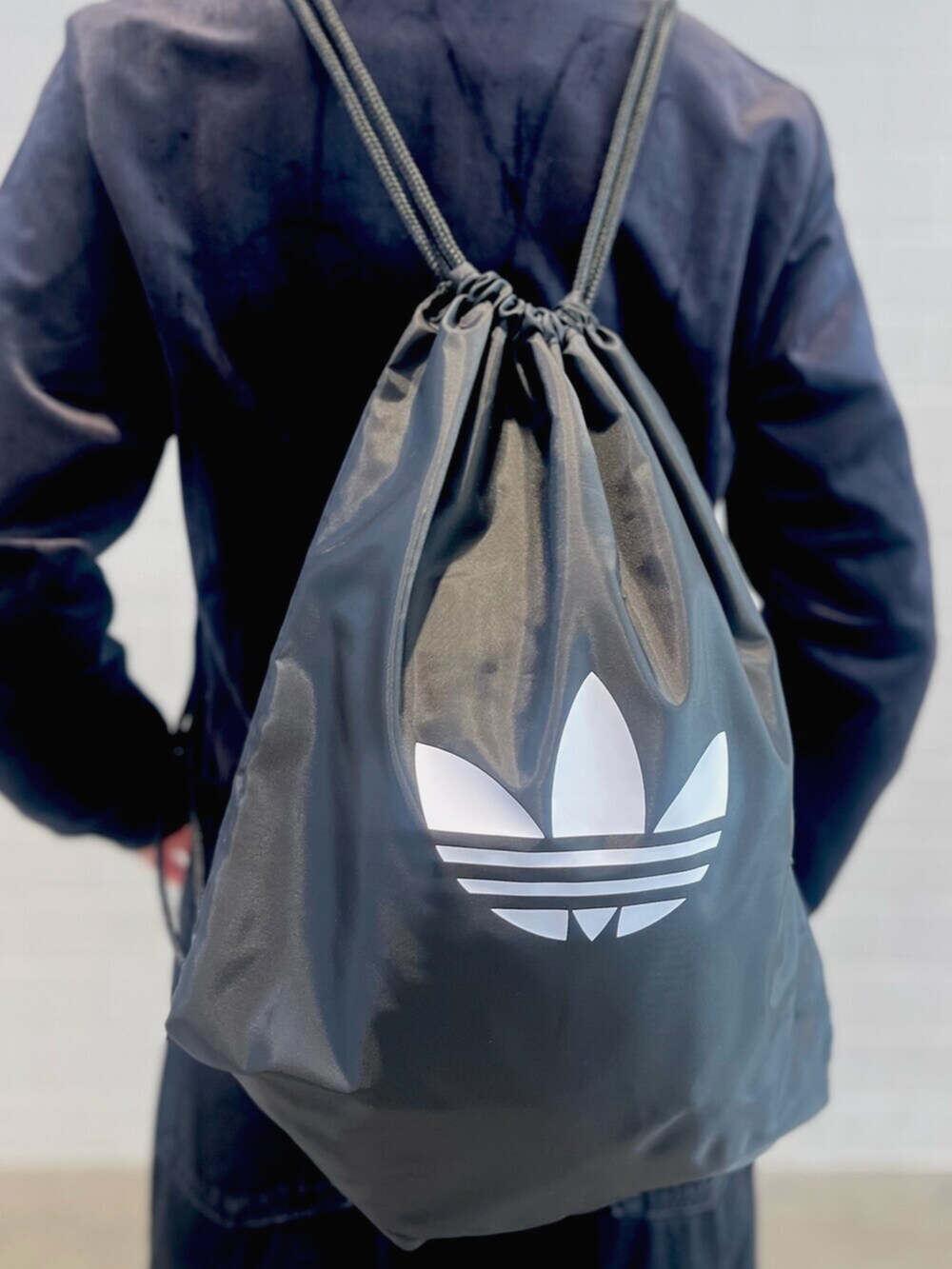 ブラック系のエコバッグ/サブバッグ、ブラック系のデニムパンツ、ブラック系のシューズを着用したレディースの冬コーディネートの4枚目の写真