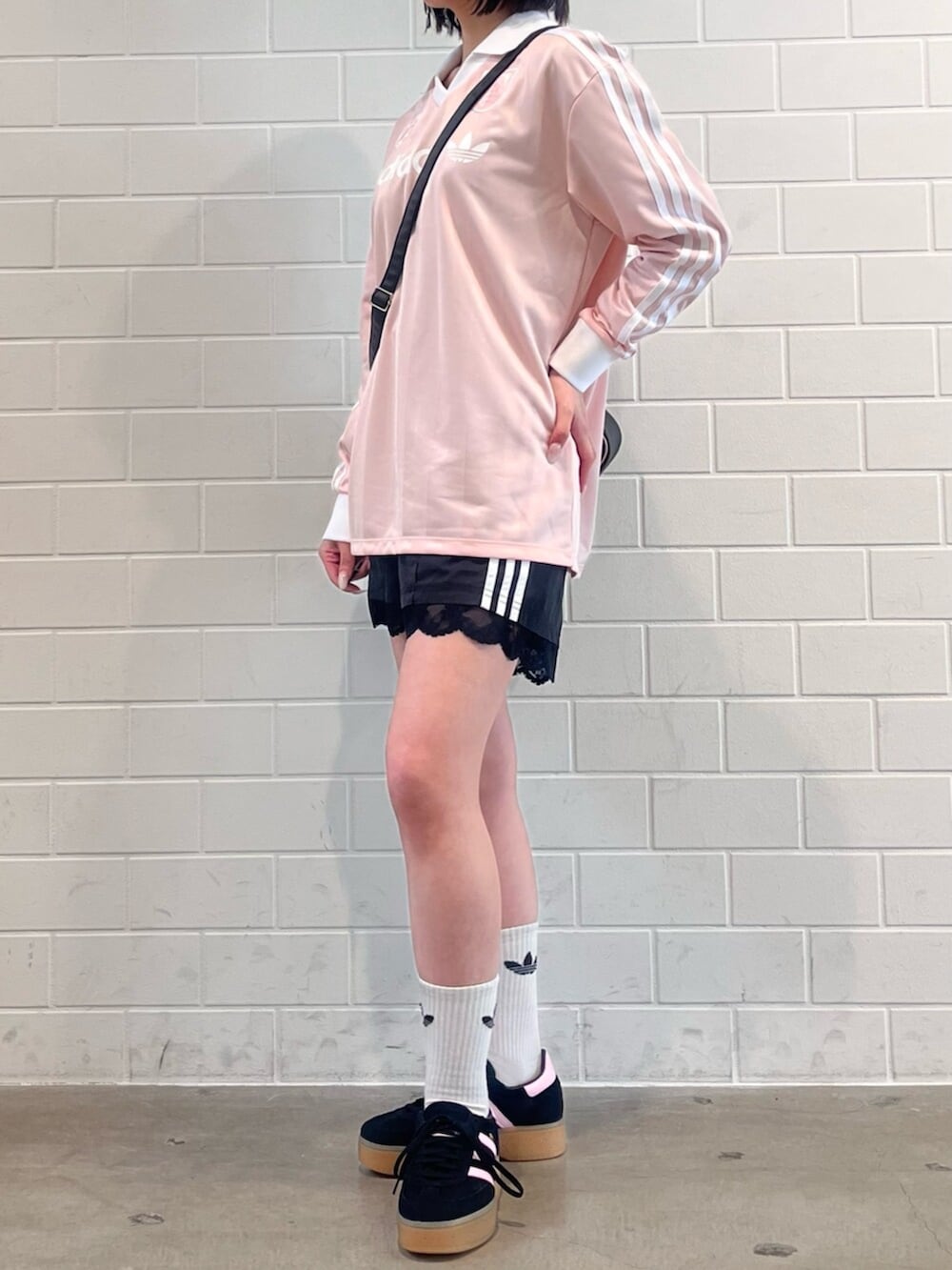 ブラック系のその他パンツ、ブラウン系のショルダーバッグ、ブラック系のスニーカーを着用したレディースの春コーディネートの2枚目の写真