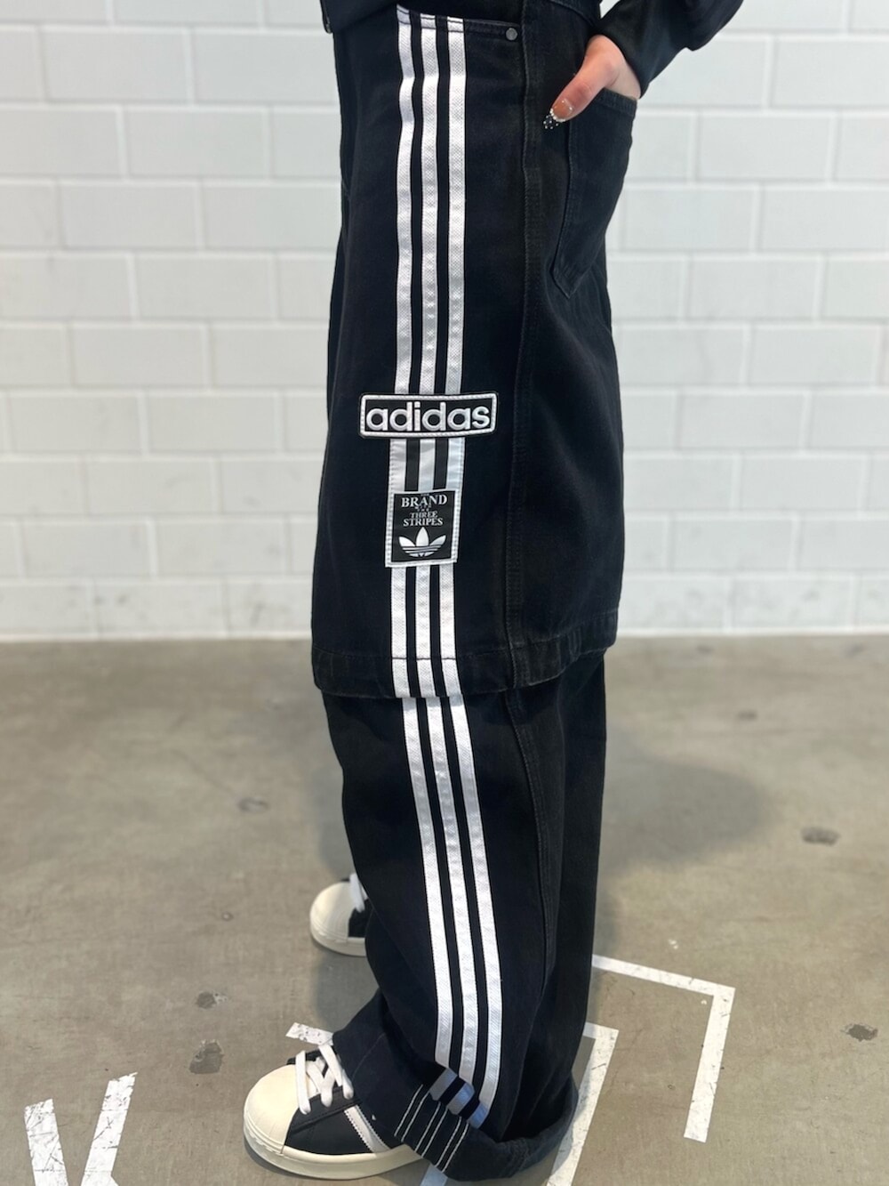 ブラック系のエコバッグ/サブバッグ、ブラック系のデニムパンツ、ブラック系のシューズを着用したレディースの冬コーディネートの5枚目の写真