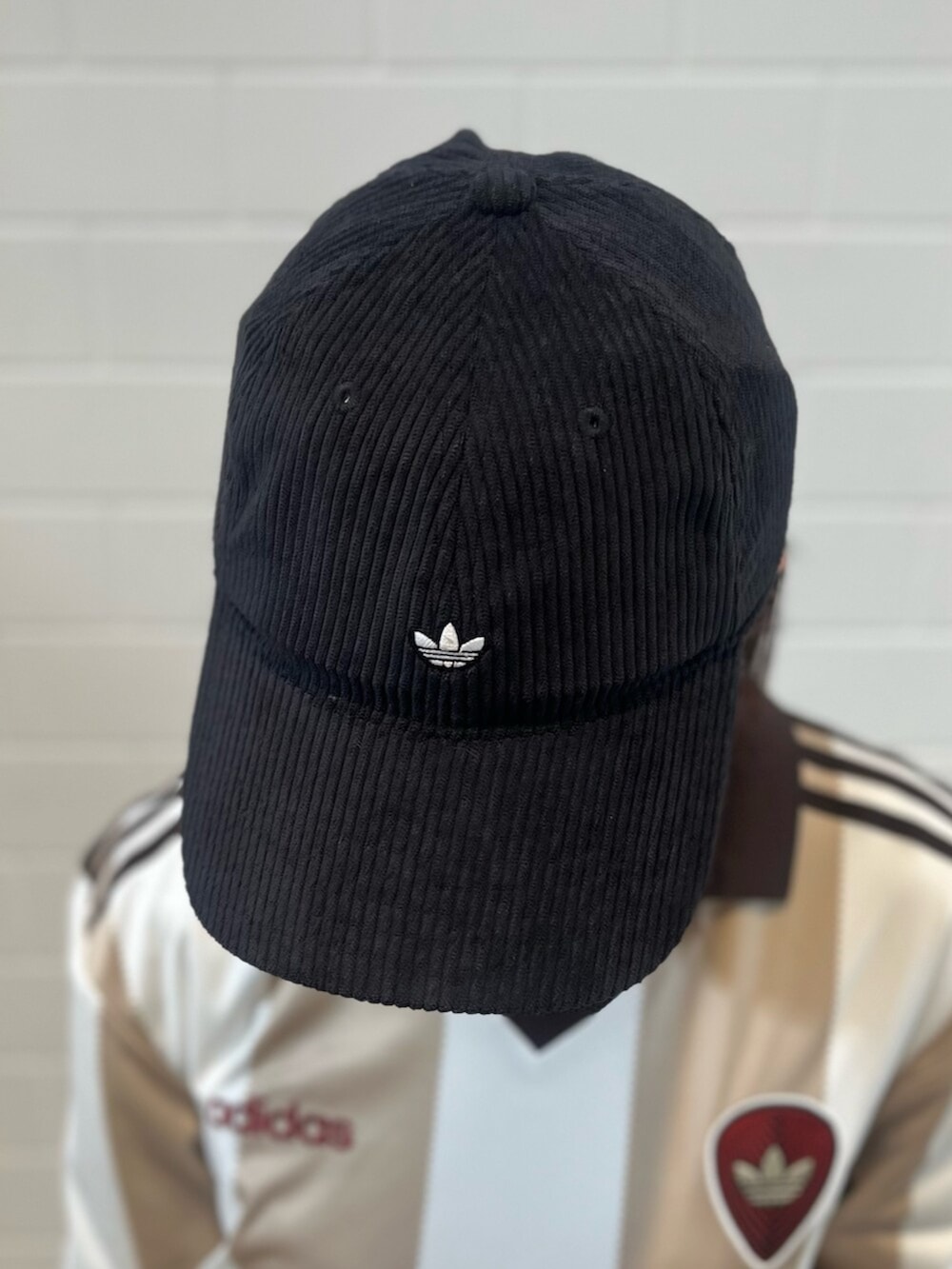 ブラック系のショルダーバッグ、ブラック系のスニーカー、ホワイト系のトップスを着用したレディースの冬コーディネートの3枚目の写真