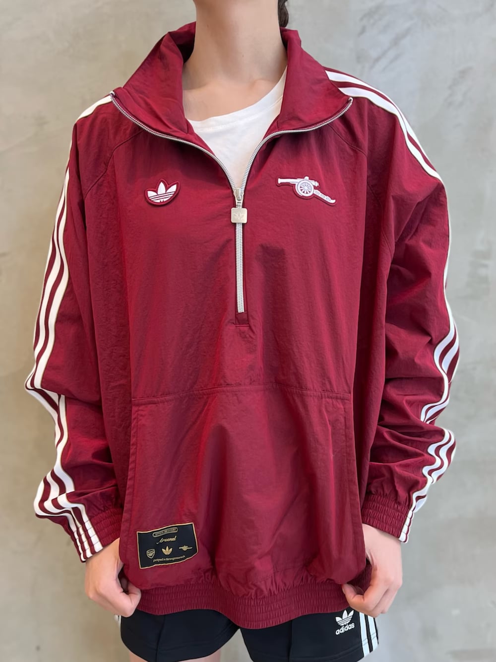 シルバー系のシューズ、シルバー系のショルダーバッグ、レッド系のトップスを着用したレディースの夏コーディネートの3枚目の写真