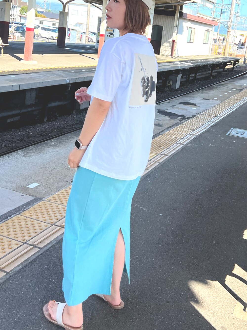 ホワイト系のTシャツ/カットソー、ブルー系のワンピース、ベージュ系のサンダルを着用したレディースの冬コーディネートの2枚目の写真