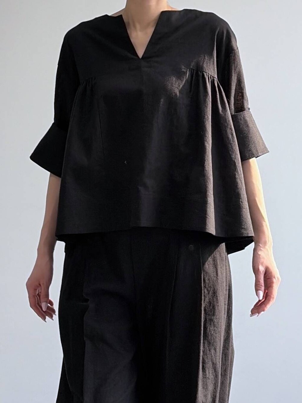 ブラック系のその他パンツ、ブラック系のシャツ/ブラウス、ブラック系のパンプスを着用したレディースの冬コーディネートの4枚目の写真