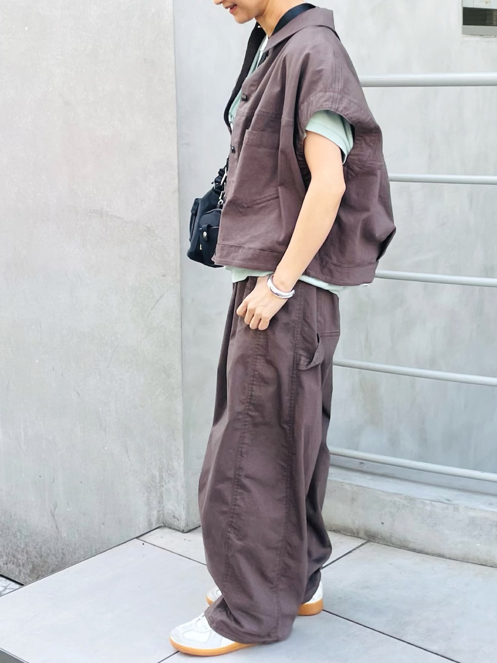 ブラウン系のベスト、グレー系のデニムパンツ、グリーン系のTシャツ/カットソーを着用したレディースの夏コーディネートの2枚目の写真