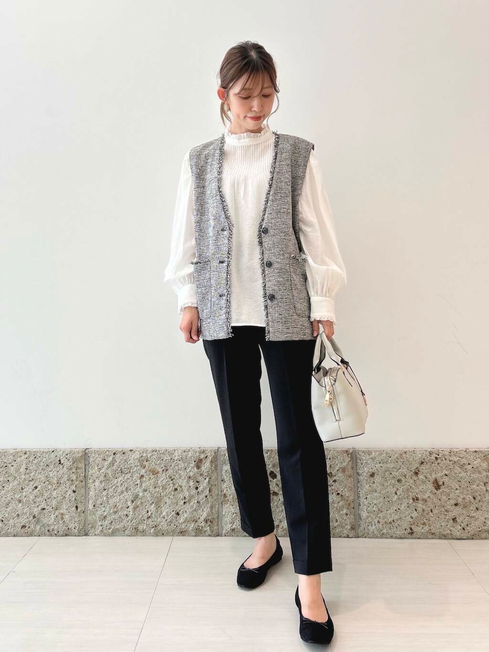 ブラック系のバレエシューズ、グレー系のベスト、ブラック系のその他パンツを着用したレディースの秋コーディネートの2枚目の写真