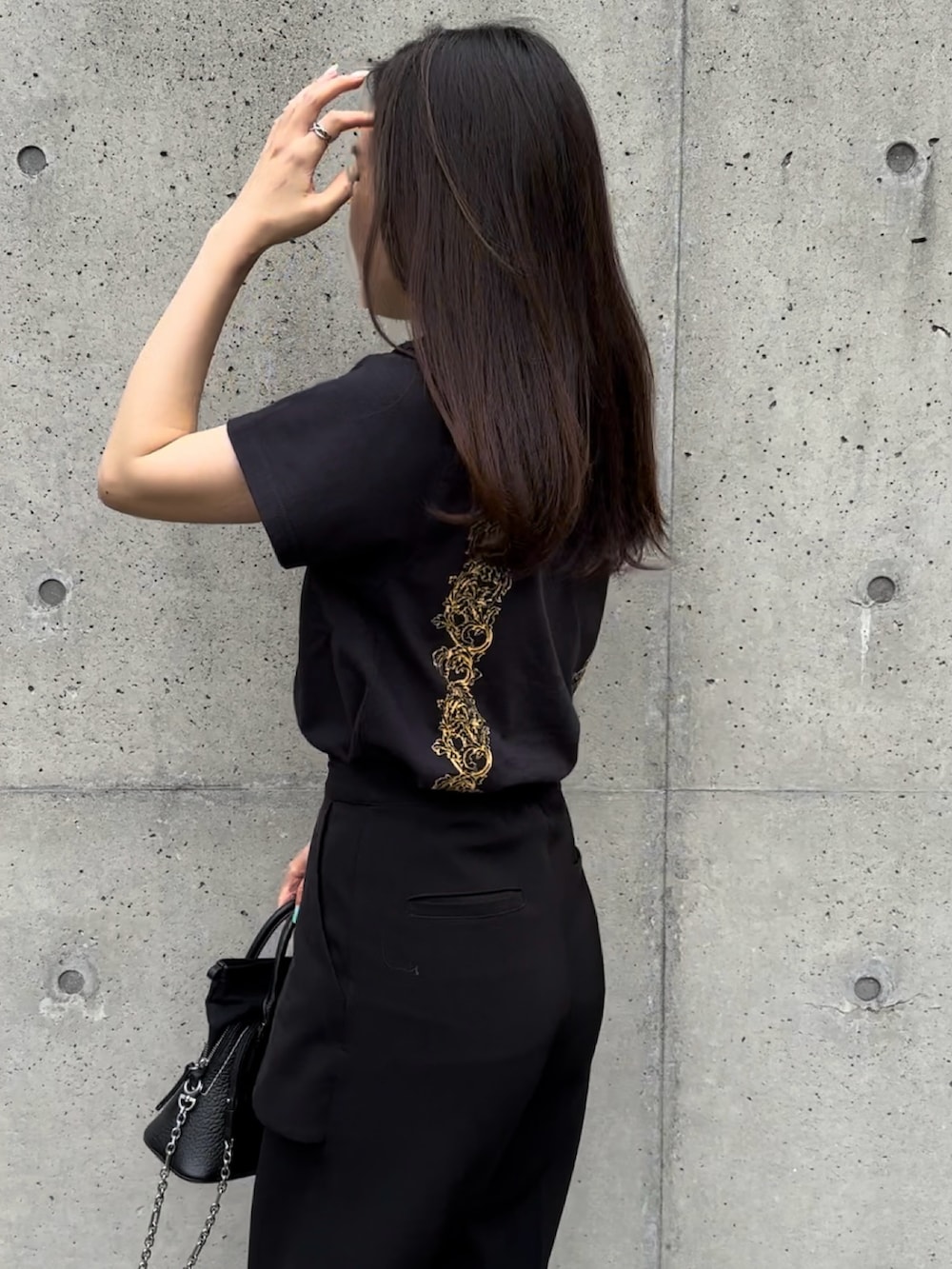 ブラック系のショルダーバッグ、ブラック系のその他パンツ、ブラック系のTシャツ/カットソーを着用したレディースの夏コーディネートの2枚目の写真