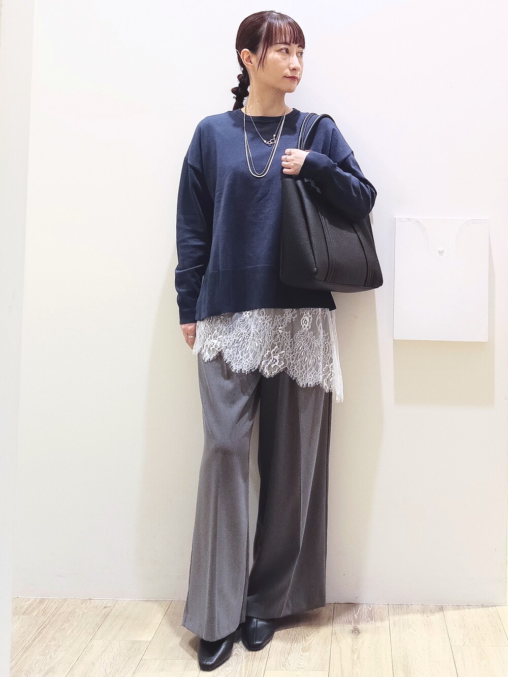 ブルー系のニット/セーター、ホワイト系のTシャツ/カットソー、グレー系のその他パンツを着用したレディースの秋コーディネートの2枚目の写真