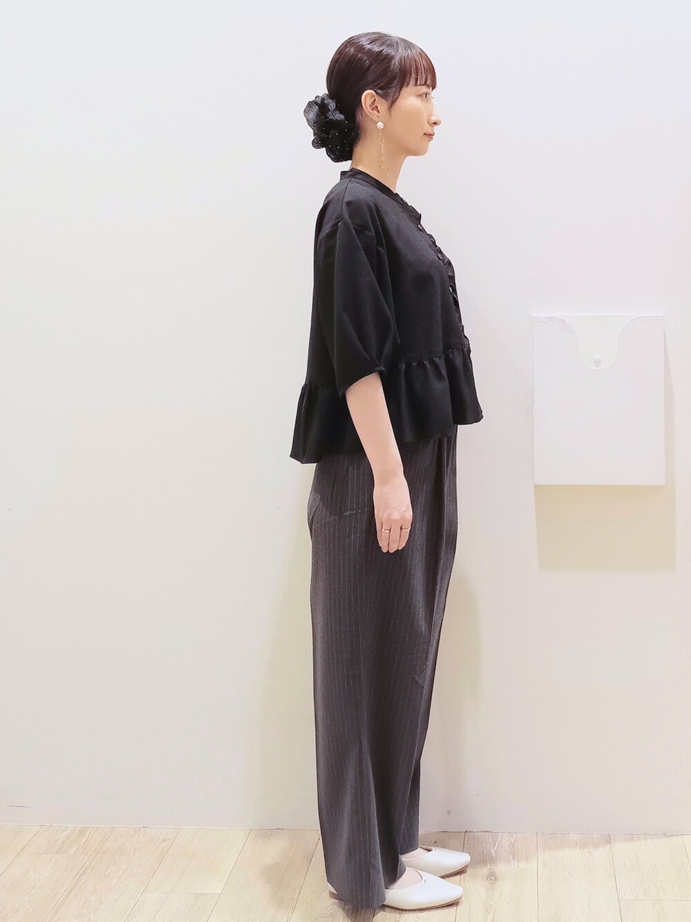 ブラック系のシャツ/ブラウス、グレー系のその他パンツ、ホワイト系のショルダーバッグを着用したレディースの秋コーディネートの4枚目の写真