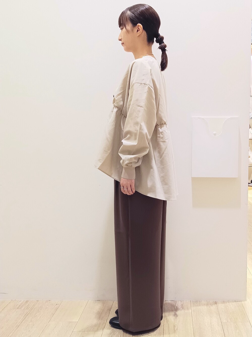 ホワイト系のTシャツ/カットソー、ベージュ系のカーディガン/ボレロ、ブラウン系のその他パンツを着用したレディースの秋コーディネートの5枚目の写真