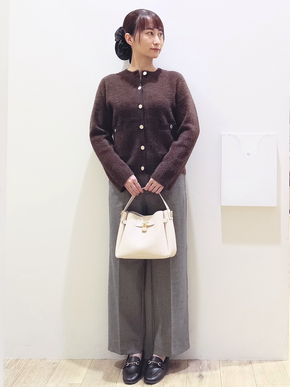 ブラウン系のカーディガン/ボレロ、ブラック系のその他パンツ、ホワイト系のトートバッグを着用したレディースの秋コーディネートの3枚目の写真