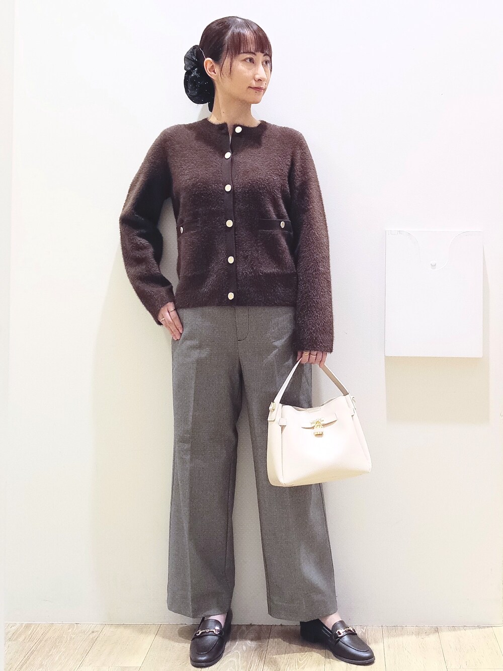 ブラウン系のカーディガン/ボレロ、ブラック系のその他パンツ、ホワイト系のトートバッグを着用したレディースの秋コーディネートの2枚目の写真